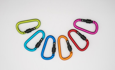 Colorful matte metal aluminum snap hook isolated on white background.