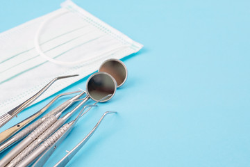 Dental tools use for dentist on the blue background, flat lay, top vipw.