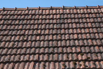 Fototapeta premium Closeup texture of old red roof tiles.Old roof at village house.