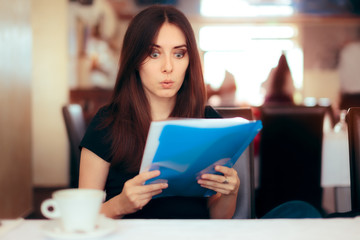 Woman Reading Important Documents in a Restaurant 