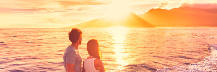 Hawaii holiday cruise ship tourists couple watching sunset on honeymoon travel vacation. Banner...