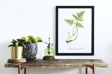 Stylish scandinavian sapce with wooden console, mock up poster frame, beautiful plants and...