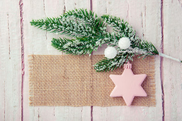 Fir branch with white balls on a wooden table as a beautiful background for the new year
