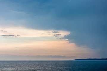 Seascape with dramatic sky and clouds on sunset