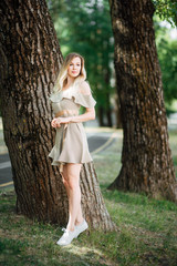 Young girl in a beautiful dress. Happy beautiful woman resting outdoors