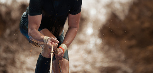 Mud race runners,during extreme obstacle races - obrazy, fototapety, plakaty