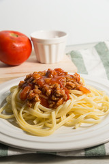 spaghetti with amatriciana sauce in the dish on the wooden table