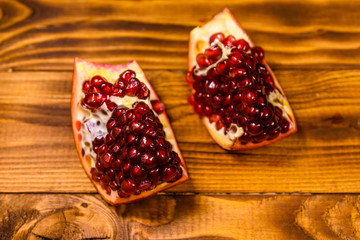 Pieces of the garnet fruit on wooden table