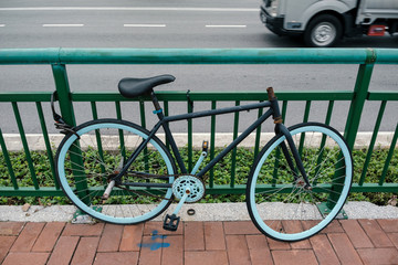 Obraz premium abundant bicycle parked and locked on fence by street