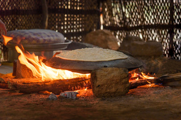 Preparing traditional bread on street market in Lorestan Province. Iran