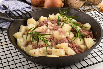 cooked corned beef hash in a cast iron pan