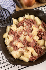 cooked corned beef hash in a cast iron pan