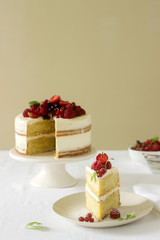 Summer home biscuit cake with curd cream, decorated with fresh berries of strawberries, raspberries and currants.