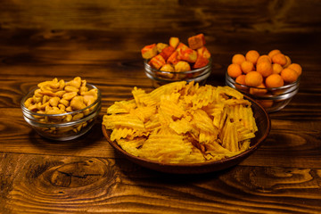 Different snacks for beer on wooden table