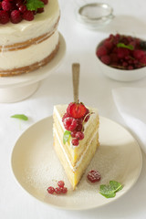 Summer home biscuit cake with curd cream, decorated with fresh berries of strawberries, raspberries and currants.