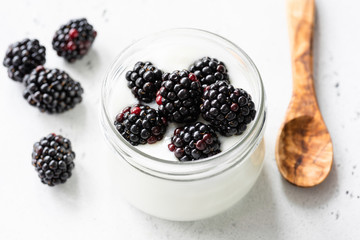 Jar of yogurt with blackberries. Healthy eating, natural food, nutrition and dieting concept