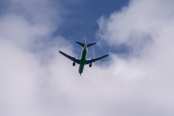 The plane flies against the sky.
