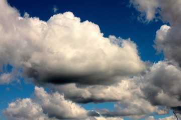 white clouds on background of dark blue sky