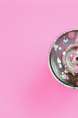 Used spray can with pink paint drips lie on texture background of fashion pastel pink color paper...
