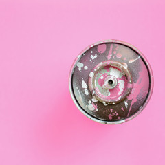 Used spray can with pink paint drips lie on texture background of fashion pastel pink color paper in minimal concept