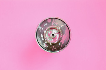 Used spray can with pink paint drips lie on texture background of fashion pastel pink color paper...