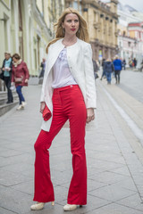 Fashionable young blonde in a spring fashionable suit and with a shopping bag in the center of Moscow
