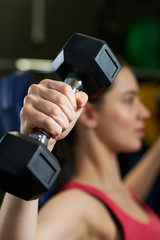Woman In Gym Exercising With Weights
