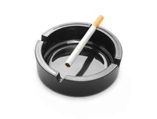 Cigarette in black ashtray isolated on white background