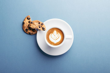A cup of coffee and american cookies with chocolate chips on grey background. Top view. - Powered by Adobe