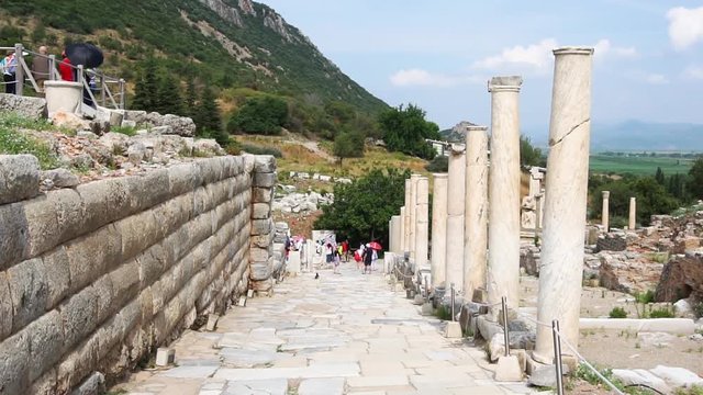 EPHESUS, TURKEY - JUNE 20, 2018 : Ruins in historical ancient city Ephesus with restoration and people around on cloudy sky in Izmir, Turkey.