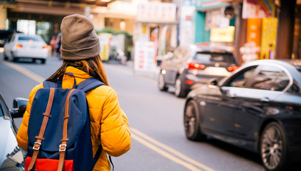 Back side asian woman travel backpack walking in the city at Taipei,travel concept background.vintage tone.