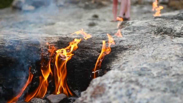 fire burns from under the stones
