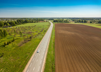 Spring arable land. A field and  road. View from above.