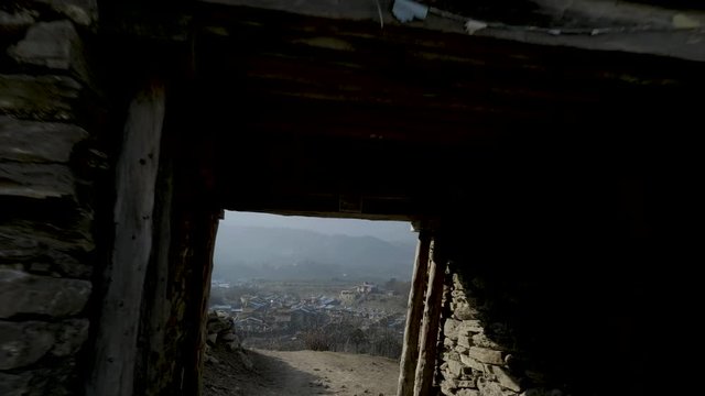 Entrance gate to nepalese village Sama Gaon among the mountains.