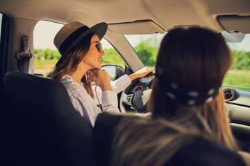 Two young women having fun driving