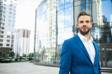 Fototapeta premium Waist up portrait of successful businessman resting after work outdoor in city. He is looking forward pensively. Copy space 