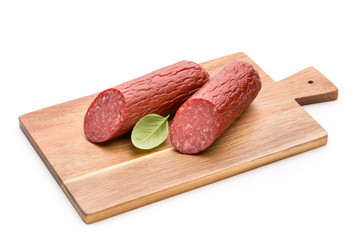 Salami smoked sausage, basil leaves on white background cutout.