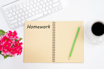 Education concept. Homework message on notebook with keyboard, pencil and coffee cup on white background.