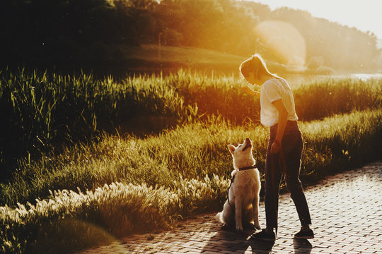 Young Woman With Dog In Nature