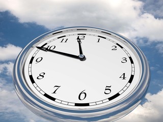 Large clock face with hands that mark the hours on sky background