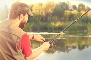 Young man fishing on a river
