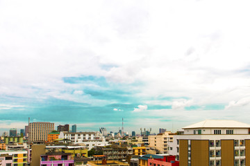 Obraz premium Bird view over cityscape with sun and clouds in the morning.Copy space.Bangkok.Pastel tone.