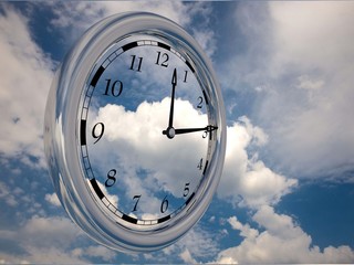 Large clock face with hands that mark the hours on sky background