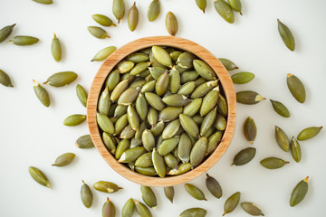 Pumpkin seeds on white background, top view
