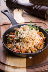 Spaghetti with meat on frying pan