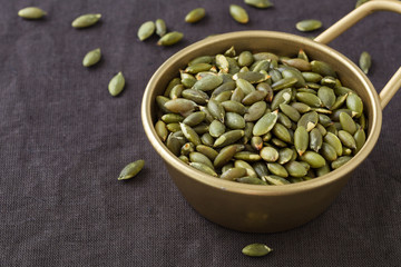 Pumpkin seeds background with space
