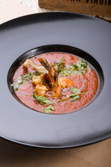 Red thick chowder soup with shrimps