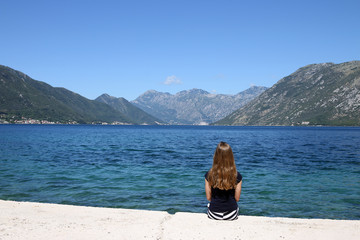 the girl enjoys a summer holiday at sea Kotor bay Montenegro
