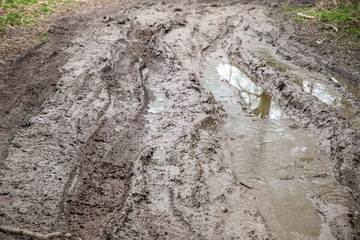 Muddy trail with tire tracks next to River Cole in England