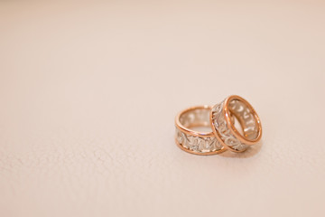 wedding rings on peach background